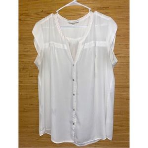Woman’s white sleeveless button down top.